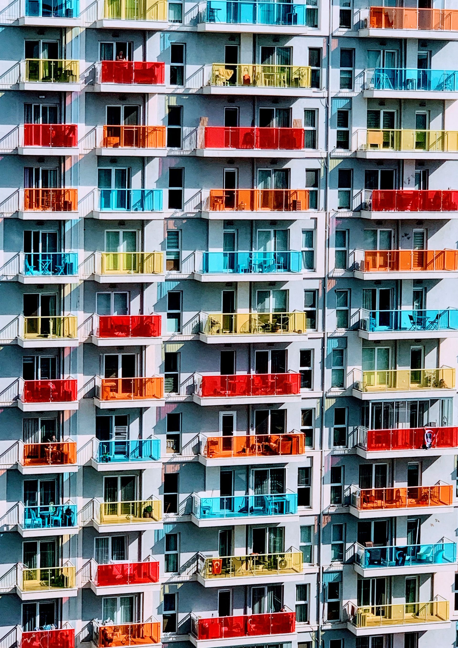 Vibrant facade of apartment building in Karşıyaka, İzmir, featuring colorful balconies.